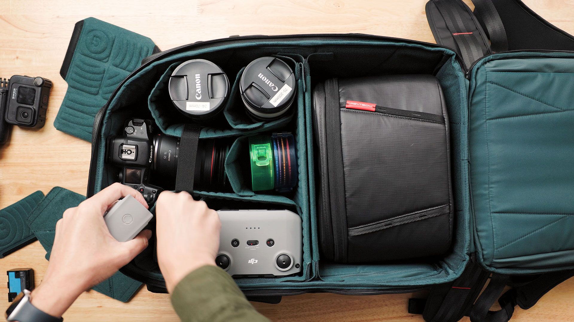 Organizing camera gear and shoulder bag inside the OneMo 2